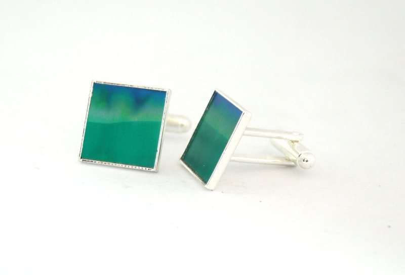 Colourful green and blue cufflinks in anodised aluminium 